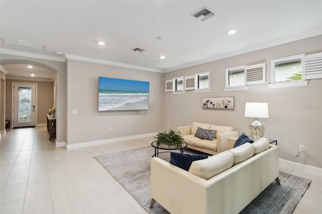 living room with arched walkways, crown molding, recessed lighting, visible vents, and baseboards