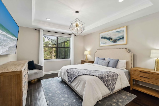 bedroom featuring a chandelier, recessed lighting, dark wood-type flooring, a raised ceiling, and crown molding