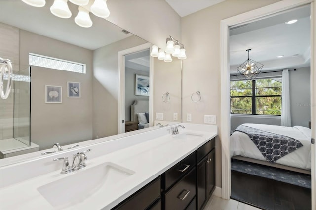 ensuite bathroom with a sink, double vanity, ensuite bath, and an inviting chandelier