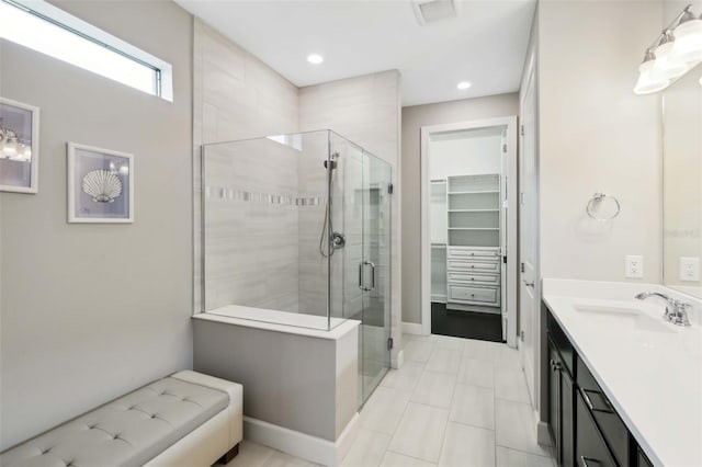 full bath with recessed lighting, visible vents, a spacious closet, a shower stall, and vanity