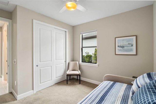 bedroom with carpet floors, a closet, baseboards, and a ceiling fan