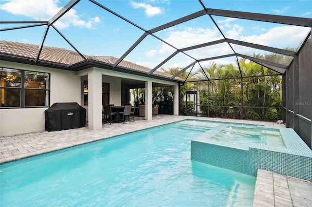 view of pool featuring a grill, a pool with connected hot tub, and a patio