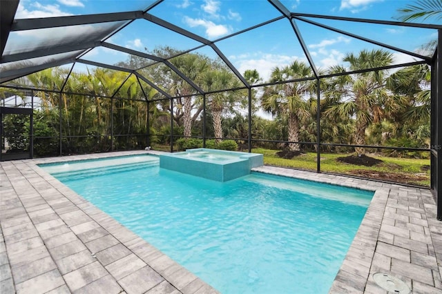 view of pool with a patio, glass enclosure, and a pool with connected hot tub