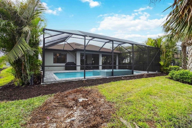 rear view of property featuring a lanai, an outdoor pool, a lawn, stucco siding, and a patio area