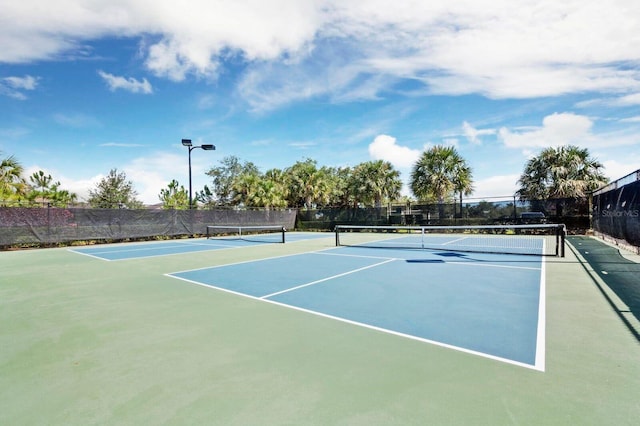 view of sport court featuring fence