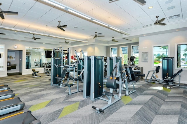 exercise room featuring carpet floors, visible vents, and baseboards