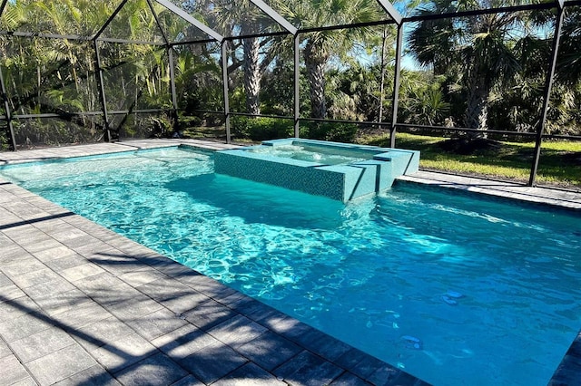 pool with glass enclosure, a patio, and an in ground hot tub