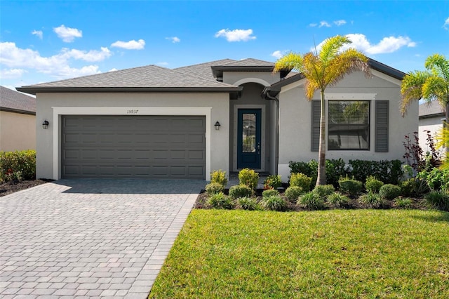 single story home featuring stucco siding, an attached garage, decorative driveway, and a front lawn