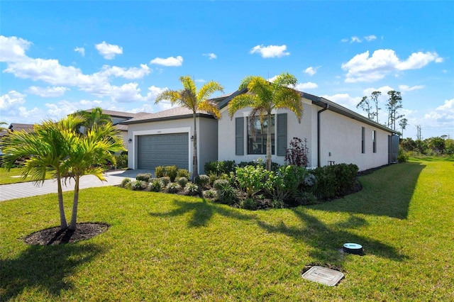 view of front facade with a front lawn, a garage, driveway, and stucco siding