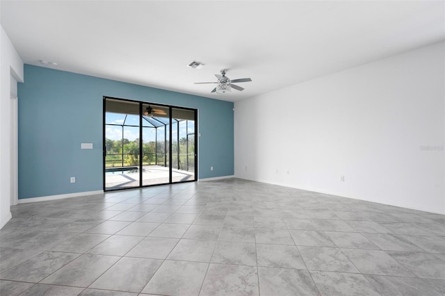 empty room with visible vents, baseboards, a ceiling fan, and a sunroom