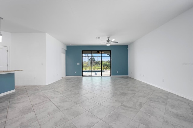 empty room featuring visible vents, baseboards, and ceiling fan