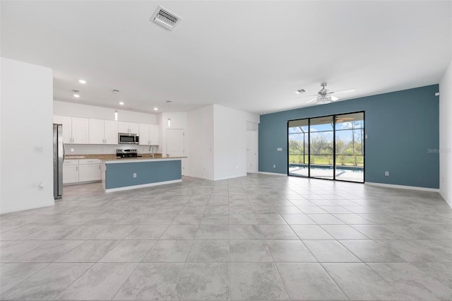 unfurnished living room with visible vents, recessed lighting, baseboards, and a ceiling fan