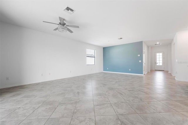 unfurnished room featuring light tile patterned flooring, plenty of natural light, visible vents, and ceiling fan