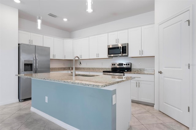 kitchen with visible vents, light tile patterned floors, light stone counters, appliances with stainless steel finishes, and a sink