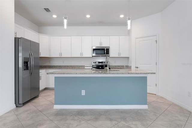 kitchen with a sink, appliances with stainless steel finishes, and white cabinets