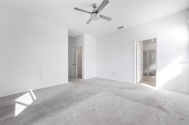 unfurnished bedroom featuring light carpet, visible vents, and baseboards