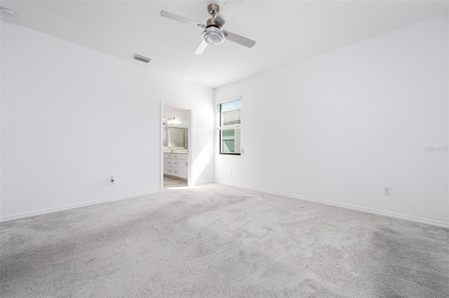 empty room with ceiling fan, baseboards, visible vents, and light carpet