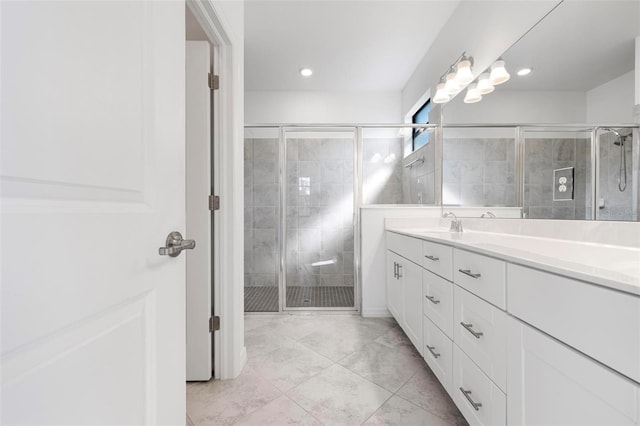 bathroom with vanity and a shower stall