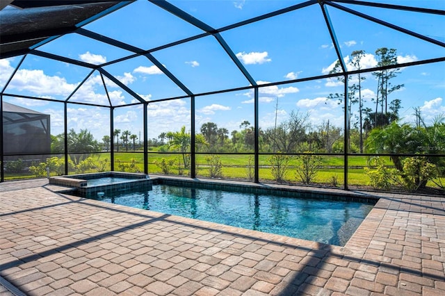 view of pool featuring a lanai, a pool with connected hot tub, and a patio