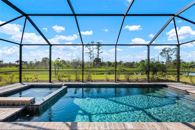 view of swimming pool featuring a lanai, a water view, and a pool with connected hot tub