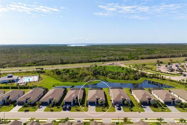 birds eye view of property with a residential view and a water view