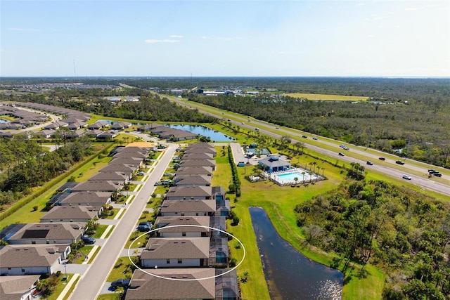 drone / aerial view with a residential view and a water view