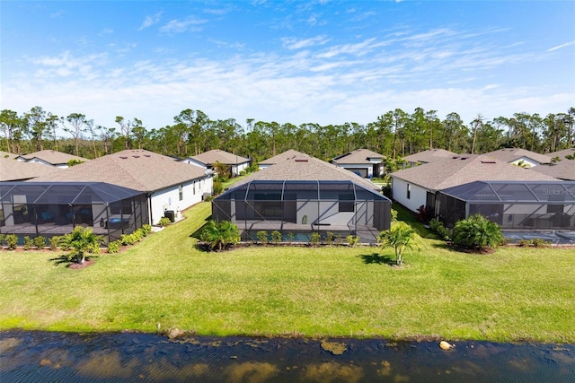 drone / aerial view featuring a residential view and a water view