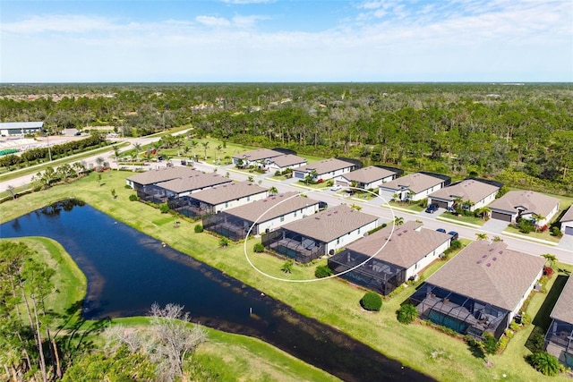 drone / aerial view with a water view and a residential view