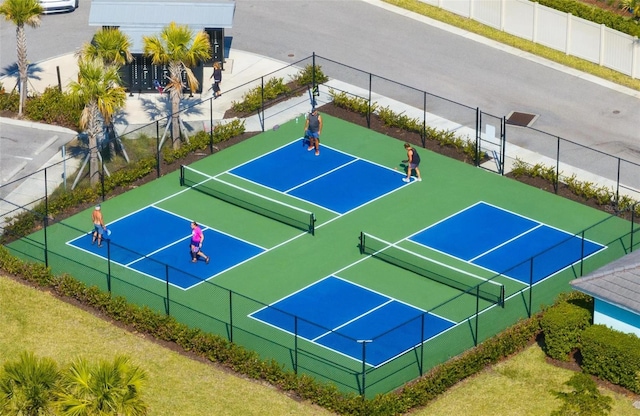 view of tennis court featuring fence