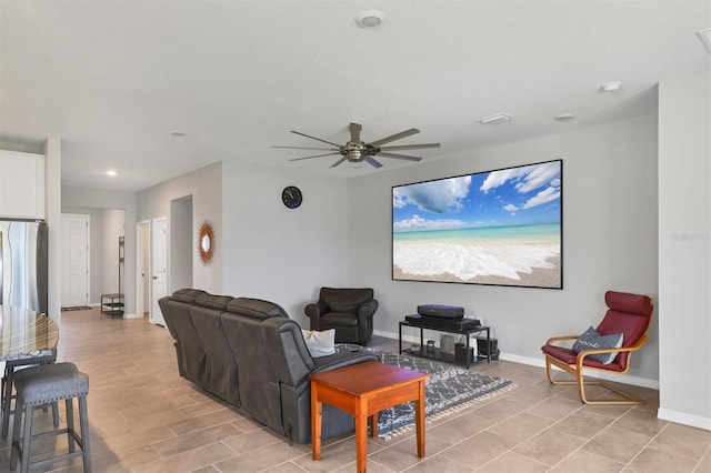 living room with ceiling fan and baseboards