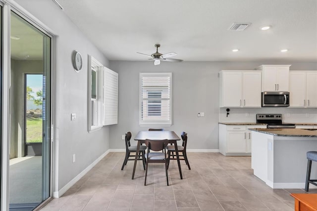 kitchen featuring recessed lighting, visible vents, appliances with stainless steel finishes, white cabinetry, and baseboards