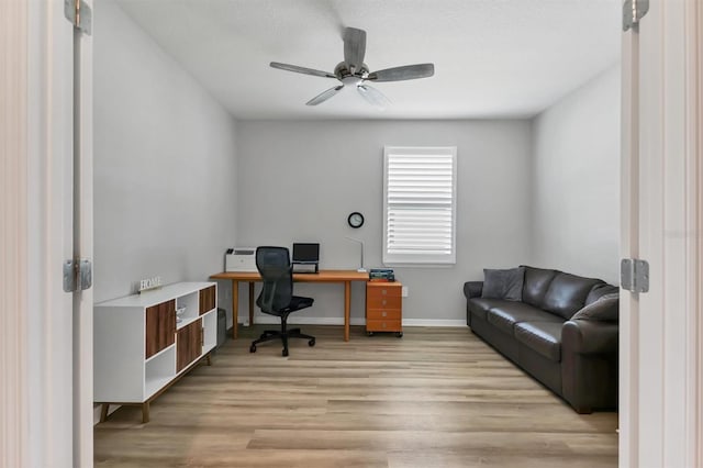 home office featuring ceiling fan, light wood-style flooring, and baseboards