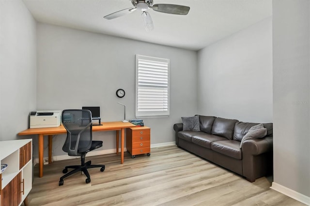 office space with a ceiling fan, light wood-style flooring, and baseboards