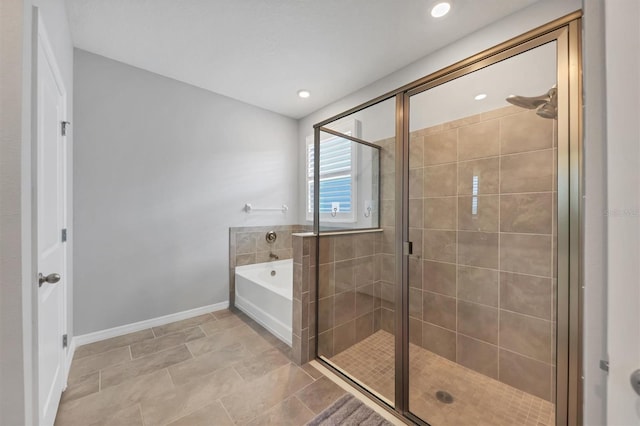 bathroom featuring a shower stall, baseboards, and a bath