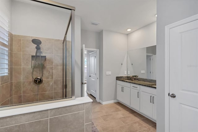 full bathroom featuring baseboards, visible vents, a tile shower, vanity, and recessed lighting