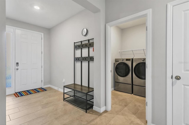 interior space with laundry area, baseboards, and independent washer and dryer