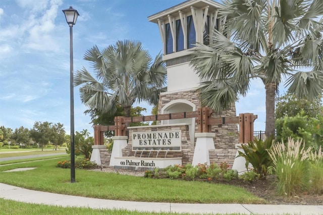 community sign featuring a lawn