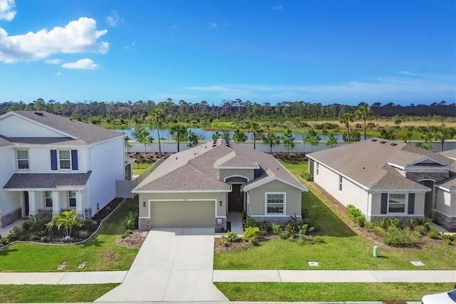 traditional-style home with a water view, a garage, and a front yard