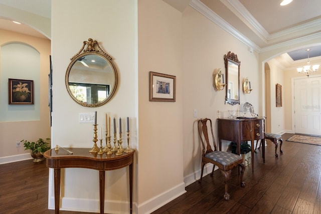 hallway featuring baseboards, wood-type flooring, and ornamental molding