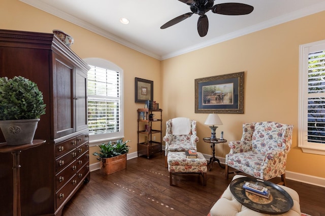 sitting room featuring dark wood finished floors, baseboards, and ornamental molding