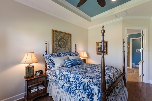 bedroom featuring a ceiling fan, baseboards, visible vents, hardwood / wood-style flooring, and crown molding