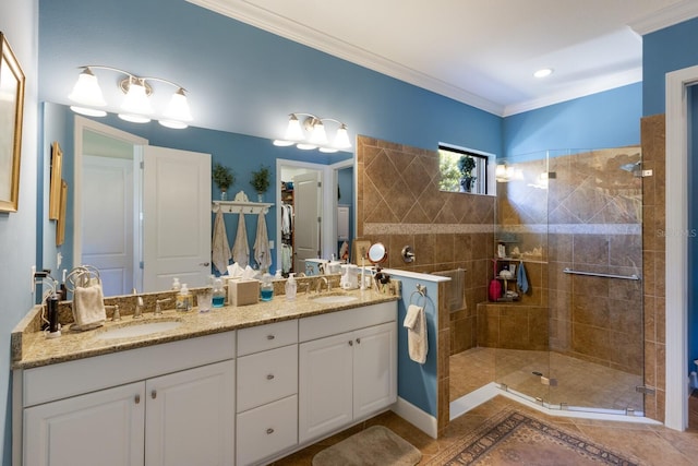 bathroom featuring ornamental molding, a stall shower, and a sink