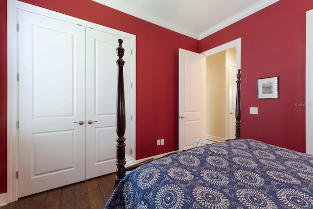 bedroom featuring a closet, ornamental molding, and dark wood-style flooring