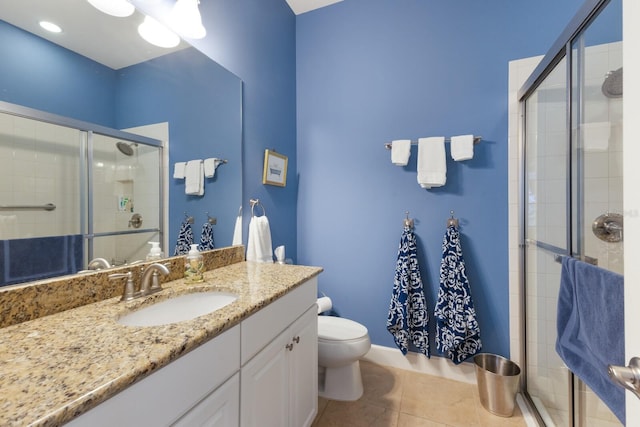 full bathroom with vanity, tile patterned floors, toilet, and a stall shower