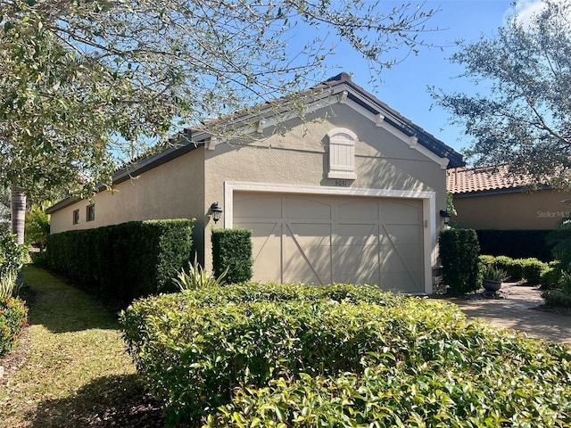 5031 Serata Dr, Bradenton, FL 34211 - view of home's exterior featuring an attached garage and stucco siding
