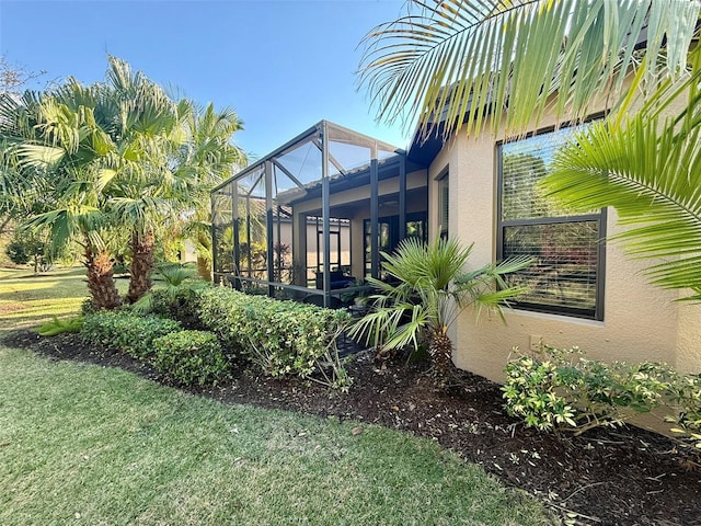 5031 Serata Dr, Bradenton, FL 34211 - view of side of property with a yard, a lanai, and stucco siding