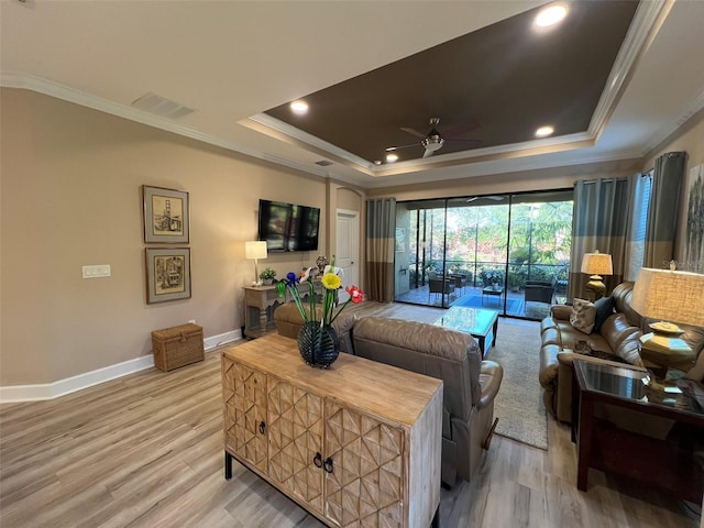 5031 Serata Dr, Bradenton, FL 34211 - living area with ornamental molding, a tray ceiling, and visible vents