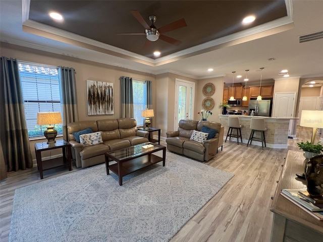 5031 Serata Dr, Bradenton, FL 34211 - living room featuring a raised ceiling, visible vents, and light wood-style floors