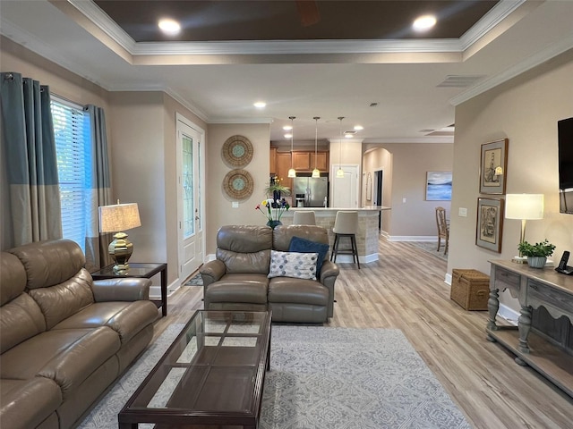 5031 Serata Dr, Bradenton, FL 34211 - living area with a tray ceiling, crown molding, and light wood finished floors