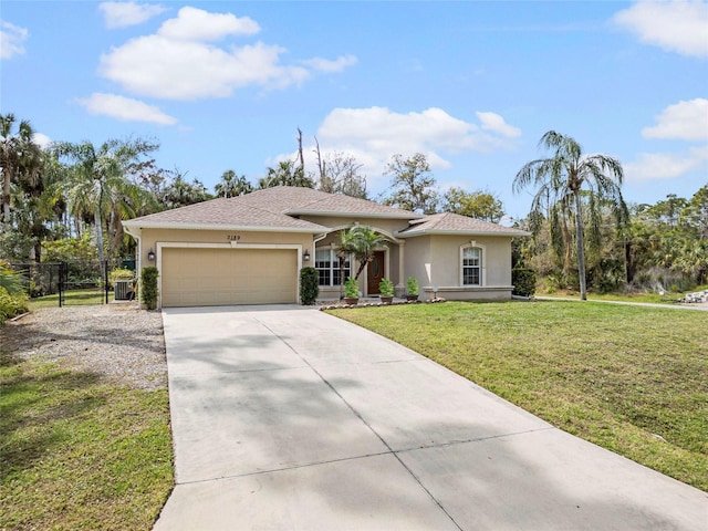 view of front of house featuring driveway, a garage, stucco siding, fence, and a front yard